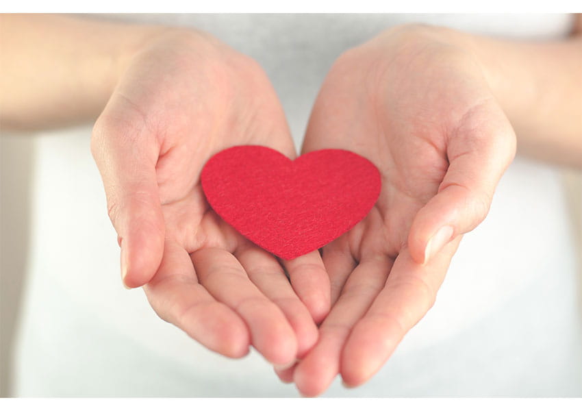 paper heart in hands